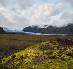 Iceland autumn tundra landscape near Haoldukvisl glacier, Iceland. Glacier tongue slides from the...