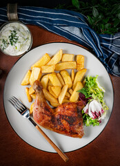 Appetizing baked chicken leg quarter.