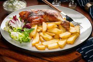Appetizing baked chicken leg quarter.