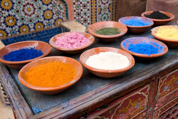 Marrakech, Morocco Clay bowls of spices and bluing with tile background.