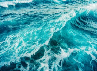 Beautiful photo of blue water flowing in waves with white foam in a ocean. Wallpaper background.