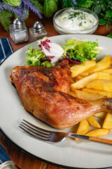 Appetizing baked chicken leg quarter.