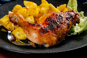 Appetizing baked chicken leg quarter.