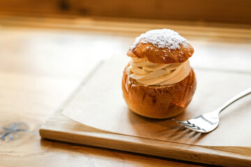 A traditional semla sweet bun dessert with almond paste topped with whipped cream - 741822672