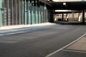empty asphalt road in downtown of modern city during daytime.