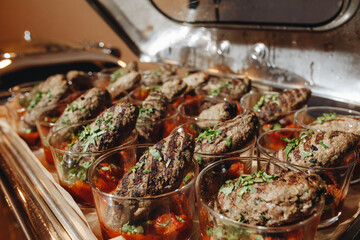 Beautifully decorated catering banquet table with different food snacks and appetizers with sandwich, caviar, fresh fruits on corporate christmas birthday party event or wedding celebration.