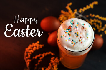 Happy Easter conceptual holiday greeting card. A glass of beer with sprinkles, Easter eggs and...