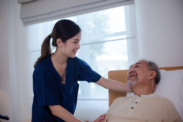 Young asian female nurse care giver helping asian senior old man in living area of nursing home senior daycare center, Nurse take care elderly patient with cheerful concentrate, health insurance