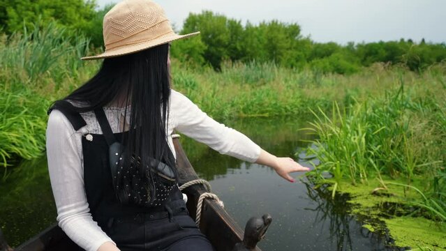 girl tourist swims in a boat on the floodplain