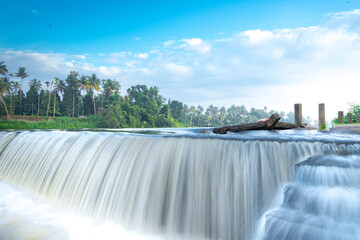 A beautiful view of a waterfall from a check dam In Kerala, India.