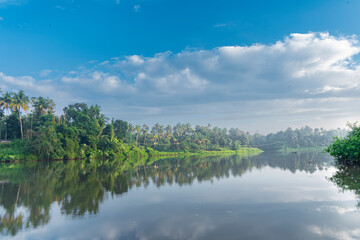 Fototapeta na wymiar A beutiful scenery of landscape with river, sky in village in kerala, india