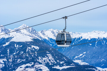 Cable car gondola against snow covered Dolomites inn Kronplatz in the winter, South Tyrol, Italy