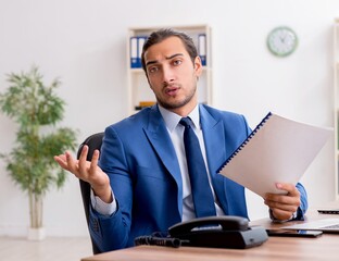 Young male businessman employee working in the office