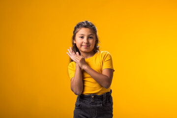 Kid girl clapping and applauding happy and joyful, smiling proud hands together