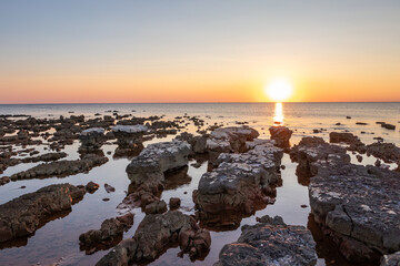 Rocks on sea in sunset - 741920869