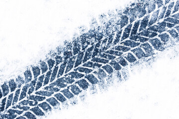 Snow tyre mark. Asphalt covered in snow. Dangerous road conditions. Car imprint on frozen ground....