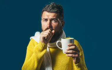 Man coughs. Sick male with cold or bronchitis coughing into his fist. Bearded handsome man in...