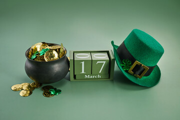 Happy St. Patrick's Day background with a leprechaun green hat full of gold coins