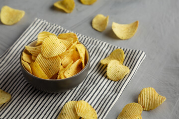 Organic Crinkle Sour Cream and Onion Potato Chips in a Bowl, side view.