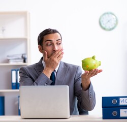 Young male accountant working in the office