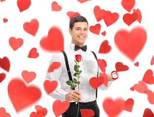 Young man under hearts holding a rose and an engagement ring