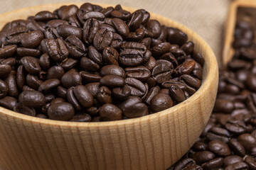 freshly roasted coffee beans in a wooden bowl