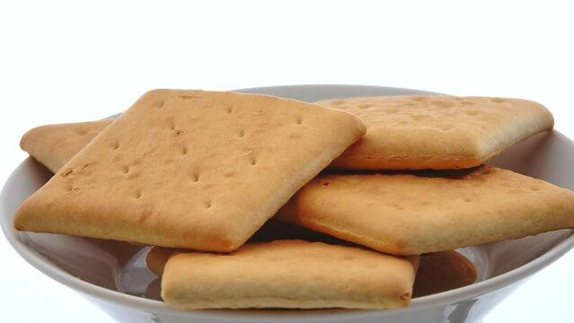 Gyration hardtack cookies on a plate on a white background.