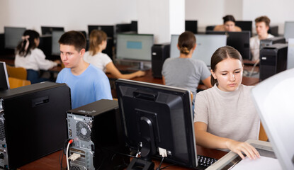 Fototapeta premium Focused girl using scanner in computer room in school