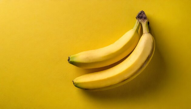 Two Bananas on a yellow background. View from the top