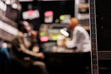 Blurred law enforcement professionals partners conducting investigation in private detective agency...