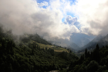 village and clouds over the mountain