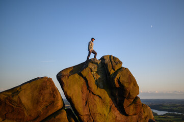 Solitary Figure Contemplating Atop a Rugged Cliff