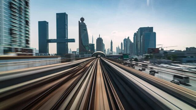 Motion timelapse POV shot from modern Dubai Metro train running alongside the Sheikh Zayed Road in Dubai, United Arab Emirates (UAE).