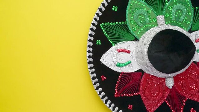 Mexican hat spinning on yellow background. Mexican Independence Day concept. Cinco de mayo background.