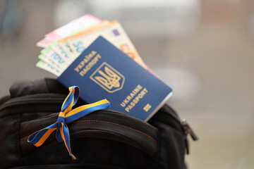Ukrainian biometrical passport and Euro money with Airlines avia tickets on touristic backpack...
