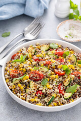 Quinoa salad with vegetables and herbs in a serving bowl