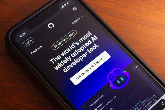 Vancouver, CANADA - Feb 14 2024 : Github Copilot website seen in iPhone. GitHub Copilot is an AI-driven code completion tool that suggests code lines or entire functions to programmers as they type.