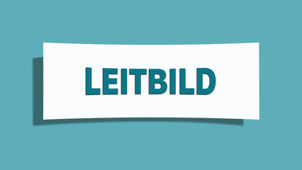 Leitbild. Eine weisse Karte mit blaugruener Schrift und Schatten, isoliert auf blaugruenem Hintergrund.