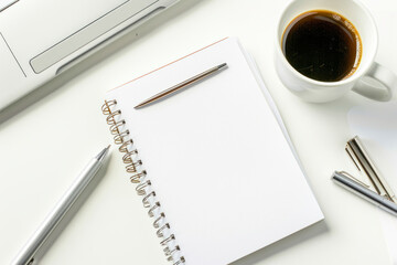 Notepad, white sticker and pensil on the desk. Flat lay, space for text.