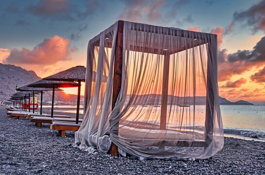 Canopy for beach loungers with curtains and parasols, sunrise, beach, Rhodes, Greece, Europe