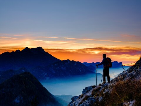 Mountaineers at dusk with a view of the Schafberg, Salzkammergut, Upper Austria, Austria, Europe