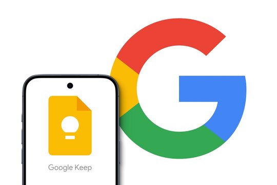 Google Keep logo is displayed on a modern smartphone, big Google Logo in the background, note-taking service included as part of the free, web-based Google Docs Editors suite offered by Google, notes