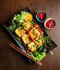 Asian vegetarian cuisine. Toasted tofu cheese with vegetables and sauce