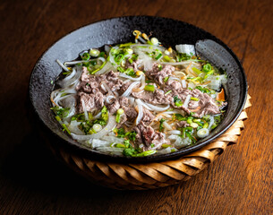 Asian beef soup in a black ceramic plate