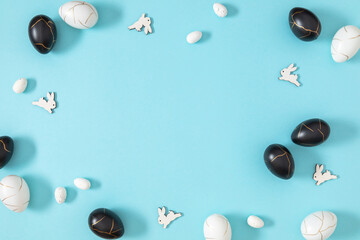 Easter holiday composition. Easter decorations, eggs, bunny rabbit on isolated pastel blue background. Easter concept. Flat lay, top view, copy space 