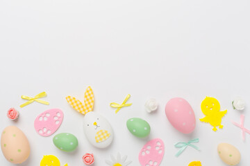 Easter eggs and decoration on color background, top view