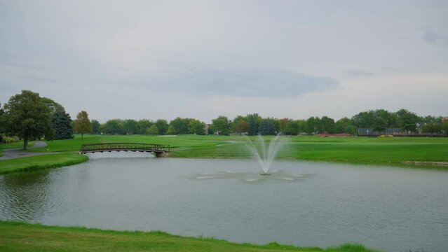 Golf course amidst water, natural landscape. Wide footage