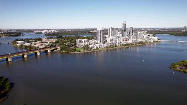 Aerial view of modern apartment buildings on an island by the river.