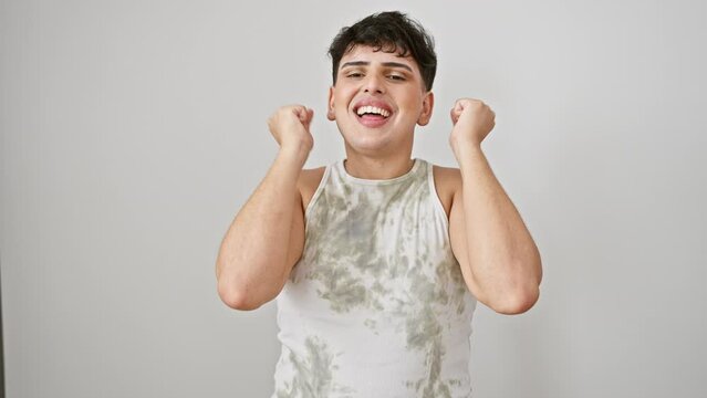 Excited young man in sleeveless t-shirt, eyes closed and arms raised, joyfully celebrating his win. isolated white background. success at its finest!