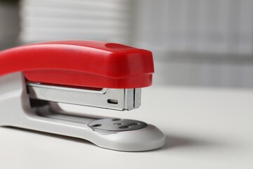 One stapler on white table, closeup. Space for text